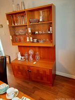 Front view of two-piece unit showing upper display shelves and lower cabinet doors