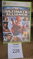 Front cover of Marvel Ultimate Alliance Xbox 360 game case showing the game title, characters including Spider-Man, and Xbox 360 branding.