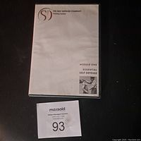 Three-disc self defense video course, showing one disc sleeve labeled Module One Essential Self Defense alongside a MaxSold auction lot number 93.