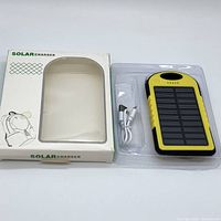 Power bank and accessories in packaging box, showing product and box design.