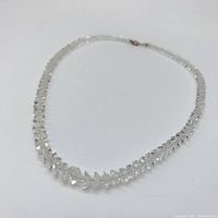 Full view of the graduated faceted quartz necklace arranged flat showing the overall length and sparkle of the stones.