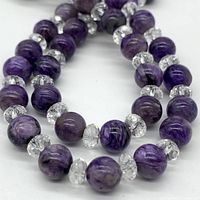 Close-up of purple amethyst beads and clear faceted crystal spacers showing bead color and pattern.