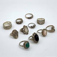 Overview of all 11 sterling silver rings arranged on white background