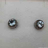 Two earrings shown from front on white background
