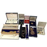 Full lot including rings in case, gold-tone necklaces and bracelets in cases, green beaded bracelet, and scissors in case.