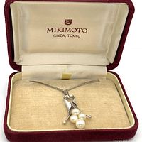 Pendant and chain displayed inside Mikimoto case