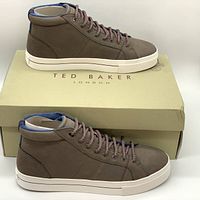 Side view showing grey leather sneaker and Ted Baker branded shoebox.