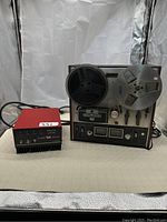 Full setup of Akai reel to reel tape recorder with Firebird amplifier, showing both units together and connected.