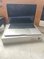 Front view of MacBook Pro laptop open on its original box