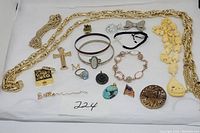 Full lot of mixed jewelry including chains, carved necklace, rings, pins, brooches