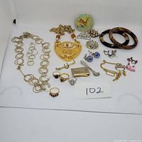 Full lot of mixed vintage and newer jewelry items arranged on a white background