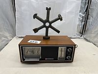 Front and top view of the Panasonic radio with the vintage wrench tool sculpture on top.