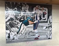 Framed signed 16x20 black and white action photograph of Brandon Graham sacking Tom Brady, visible signature with inscription.