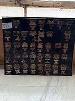 Full display board showing diverse Super Bowl commemorative pins representing different years and teams.