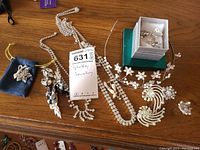 Photo of all costume jewellery laid out including necklaces, brooches, earrings, and a decorative hair vine.