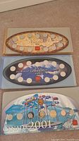 All three Royal Canadian Mint Millennium coin sets from 1999, 2000, and 2001 arranged in original display cases showing condition and design.
