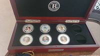Full set of six commemorative Queen Elizabeth II coins displayed inside a wooden presentation box with The Bradford Exchange logo on the lid.