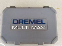 Closed gray plastic carrying case labeled Dremel Multi-Max