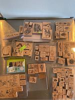 Top view displaying numerous wooden stamps with various designs on a metallic surface