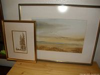 Both paintings displayed side by side showing size difference and style contrast, each framed and mounted with matting.