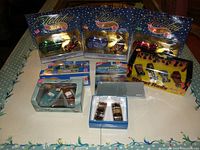 Lot overview photo showing multiple Hot Wheels sets including 3 Holiday edition sets, 50 Forever train, Action Pack Racing, and Street Rods sets.