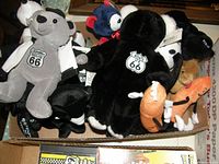Photo of multiple Route 66 themed stuffed animals, including plush bears and other animals in colors such as black, grey, and orange.