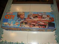 Original box showing Hot Wheels City Sto & Go branding with box featuring child and playset images.