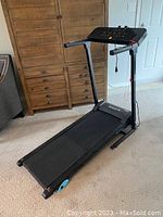 SereneLife treadmill shown fully set up on carpeted floor, with black frame, handrails, and control panel clearly visible.