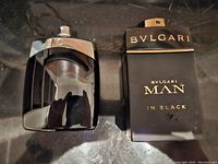 Top view showing Montblanc and Bvlgari cologne bottles side by side on a reflective surface