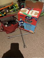 Box of Scott Shop Towels and two metal lug wrenches lying on carpet