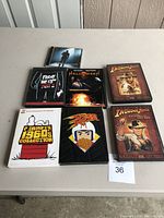 Seven DVDs laid out on a table showing titles and cover art including horror, adventure, classic TV, and animated content.