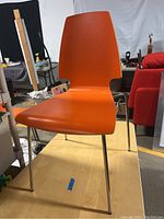 Orange IKEA Vilmar chair showing front and seat surface with chrome legs