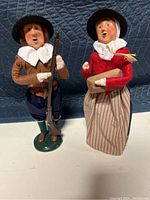 Two Buyers Choice Plymouth Plantation caroler figurines posed side by side, showing front of each with clothing and accessories.