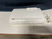 Top view of the FoodSaver vacuum food sealer showing front bag slot, control dial and power cord.