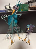 Both bird sculptures side by side, larger on left
