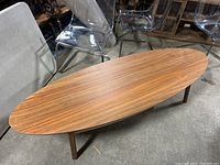 Full view of the IKEA Stockholm coffee table with natural wood grain finish and elongated oval shape.