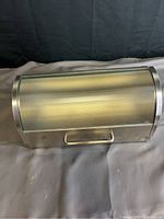 Top view showing curved roll top lid with handle and opaque window panel