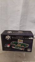 Boxed electric Ultimate Texas Hold'em poker game showing product image and details