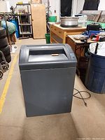 Front and side view of grey GBC Shredmaster 5260X commercial paper shredder in warehouse setting.