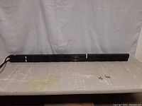 Full length view of one APC rack PDU showing overall length and power cable.