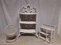 Three wicker shelving units: freestanding 3-shelf unit, square wall shelf, and half-round wall shelf, all painted white, arranged side by side.