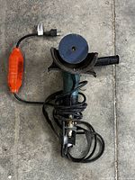 Top down view of the Makita PW5001C polisher showing the orange electronic speed control on the power cord and the 4 inch disc.
