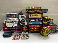 Full view of stacked board games and puzzles with electronic Bop-It and 3D maze ball