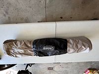 Coleman Twin Quick Bed mattress rolled up inside carrying bag with Coleman logo.