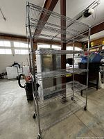 Full view of chrome wire shelving rack on wheels