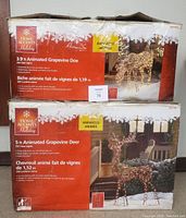 Box showing packaging for 3.9 ft Animated Grapevine Doe with 200 clear lights and 5 ft Animated Grapevine Deer buck with 250 clear lights