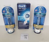 Lot of 3 new electric toothbrushes including Oral-B PRO 2000 and two sealed Arm & Hammer Spinbrush Pros