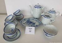Full tea set with cups, saucers, bowls, platter, teapot, creamer, and sugar bowl with MoSold lot card