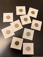 Photo shows a collection of ten Canadian pennies from 1960 to 1969.
