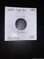 Front view of Nepal Copper Dam coin mounted on white card labeled with handwritten text 'Nepal Copper dam 1804' with additional numbers written below.